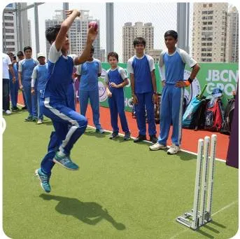 Students are practising cricket on turf
