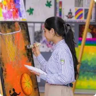Learner engaged in creative painting activity at JBCN International School