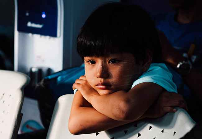 Child sitting alone in a room