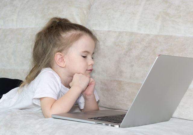 Child studying at home with a laptop during quarantine